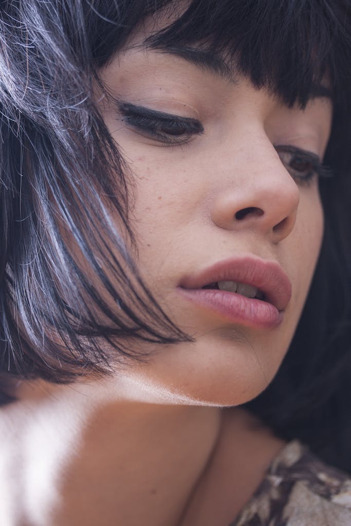 Woman Wearing Black Mascara and Eyeliner Pouting Lips