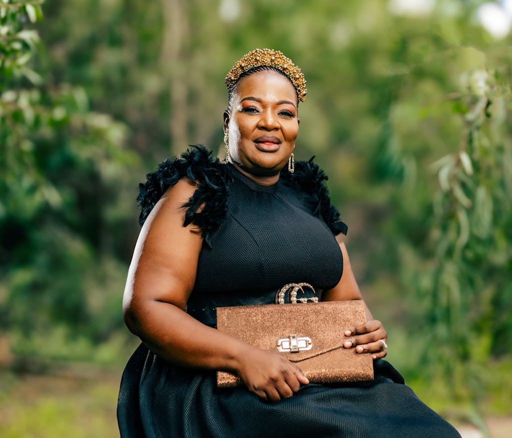 Portrait of Woman Sitting in Black Dress and with Bag