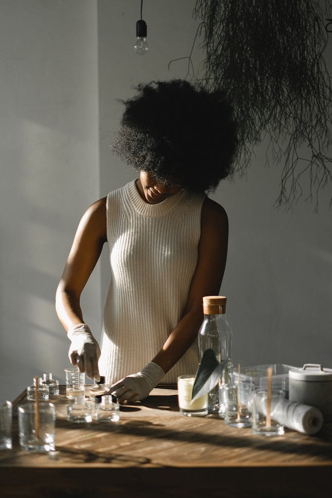 Black woman making liquid incense in workshop