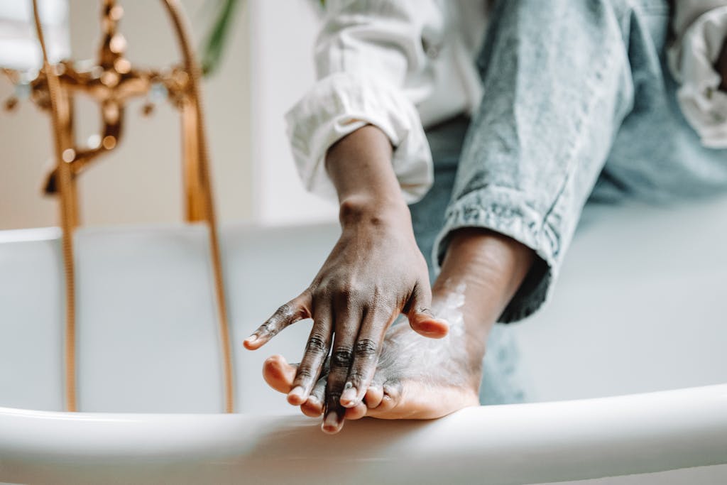 Close Up Shot of a Person Applying Cream on Her Foot