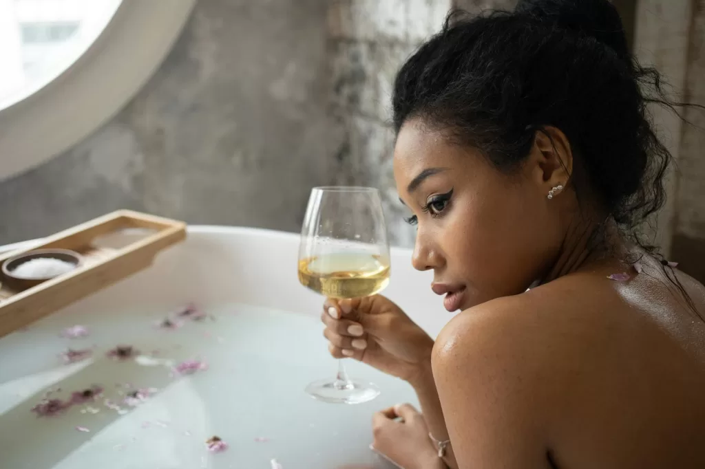 Woman pampering herself and drinking wine