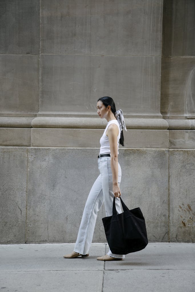 Asian woman with eco friendly bag in city