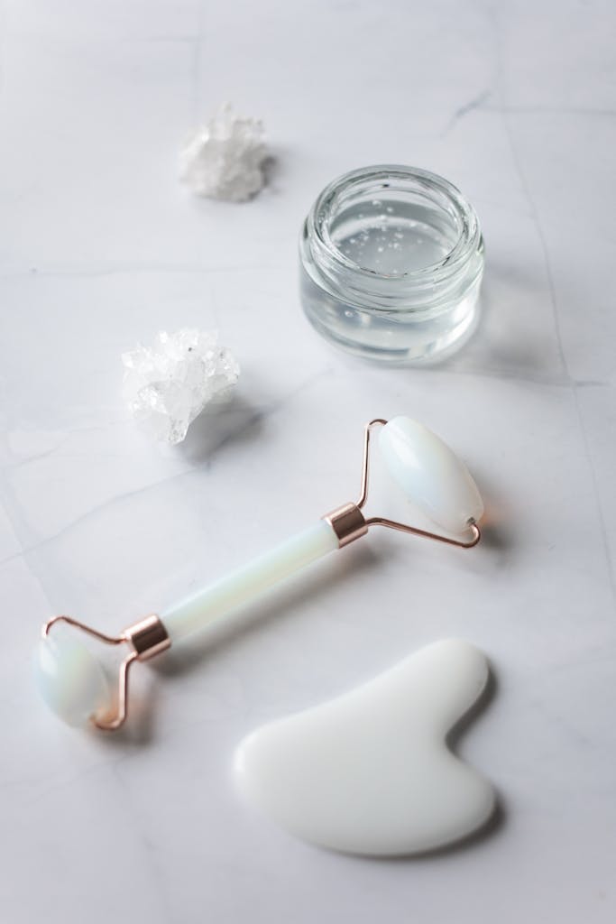 Facial massage tools placed on marble table