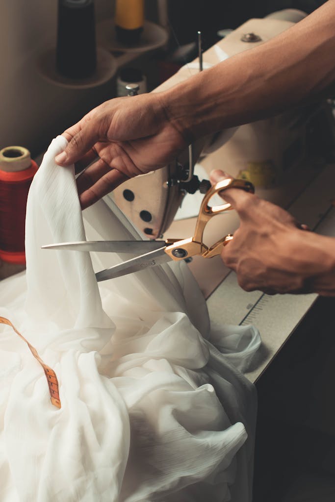 Person Cutting White Cloth